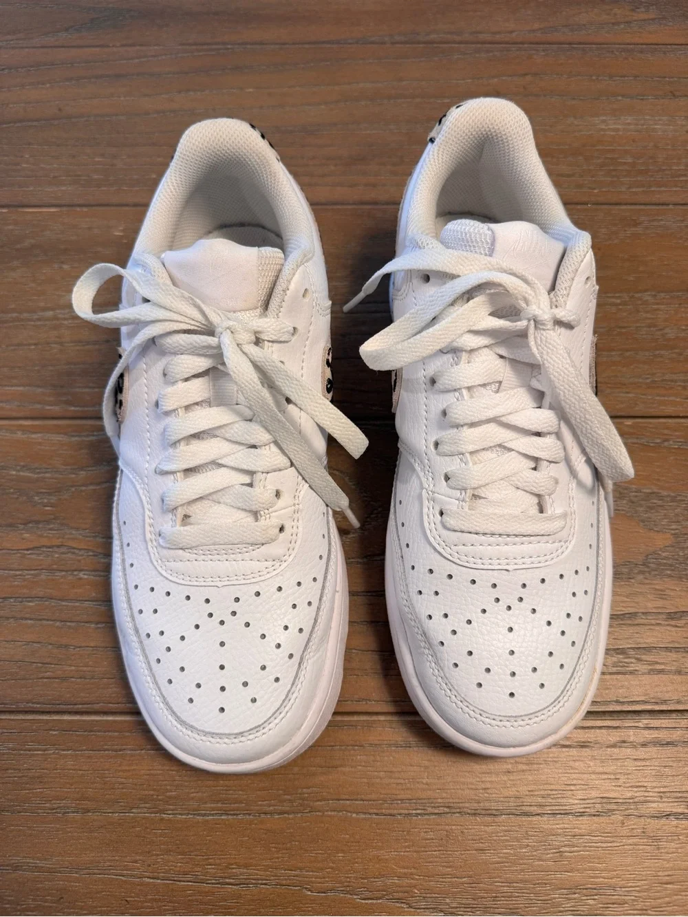 Nike White Low-Top Sneakers with Black Swoosh and Leopard Detail